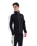 Man wearing a black and white tracksuit with a brand logo on a white background