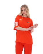 Woman wearing an Orange t-shirt with '1911' text and white stripes on sleeves, FILA logo on chest, on a white background