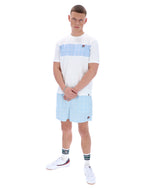 Person wearing a white and light blue striped shirt with matching shorts on a white background