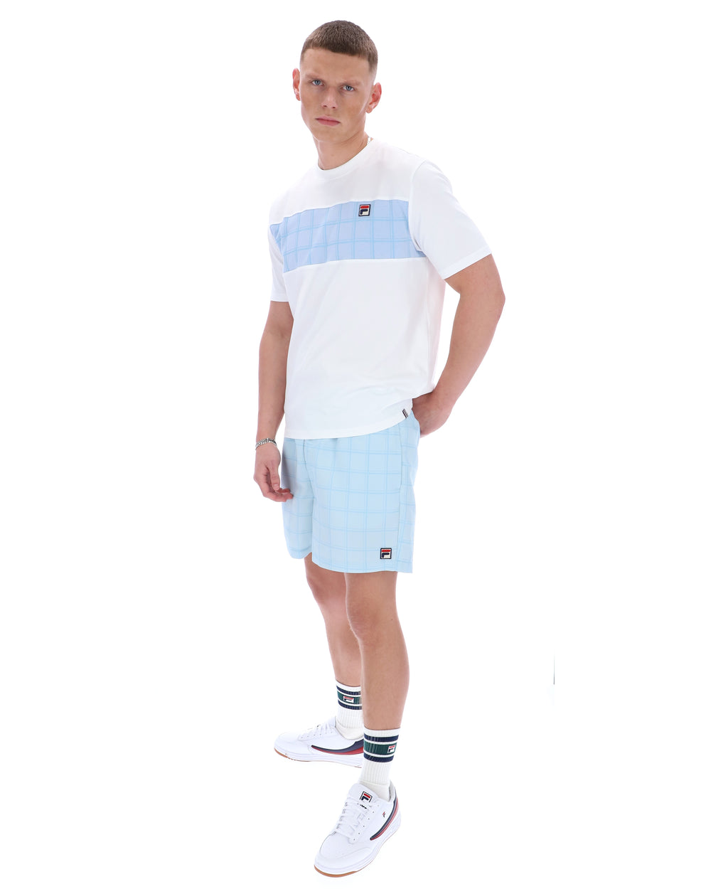 Man wearing a white and blue striped t-shirt and shorts on a white background