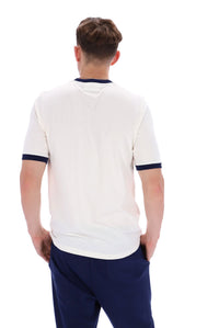 A male model wearing a white and navy ringer t-shirt with navy joggers on a white background