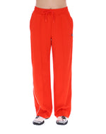 Orange sweatpants with a small FILA logo on a white background