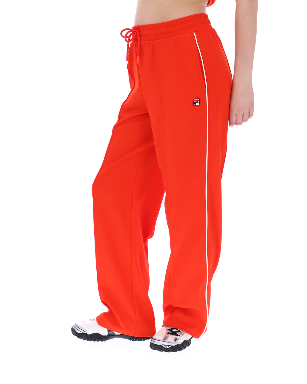 Orange sweatpants with a small FILA logo on a white background