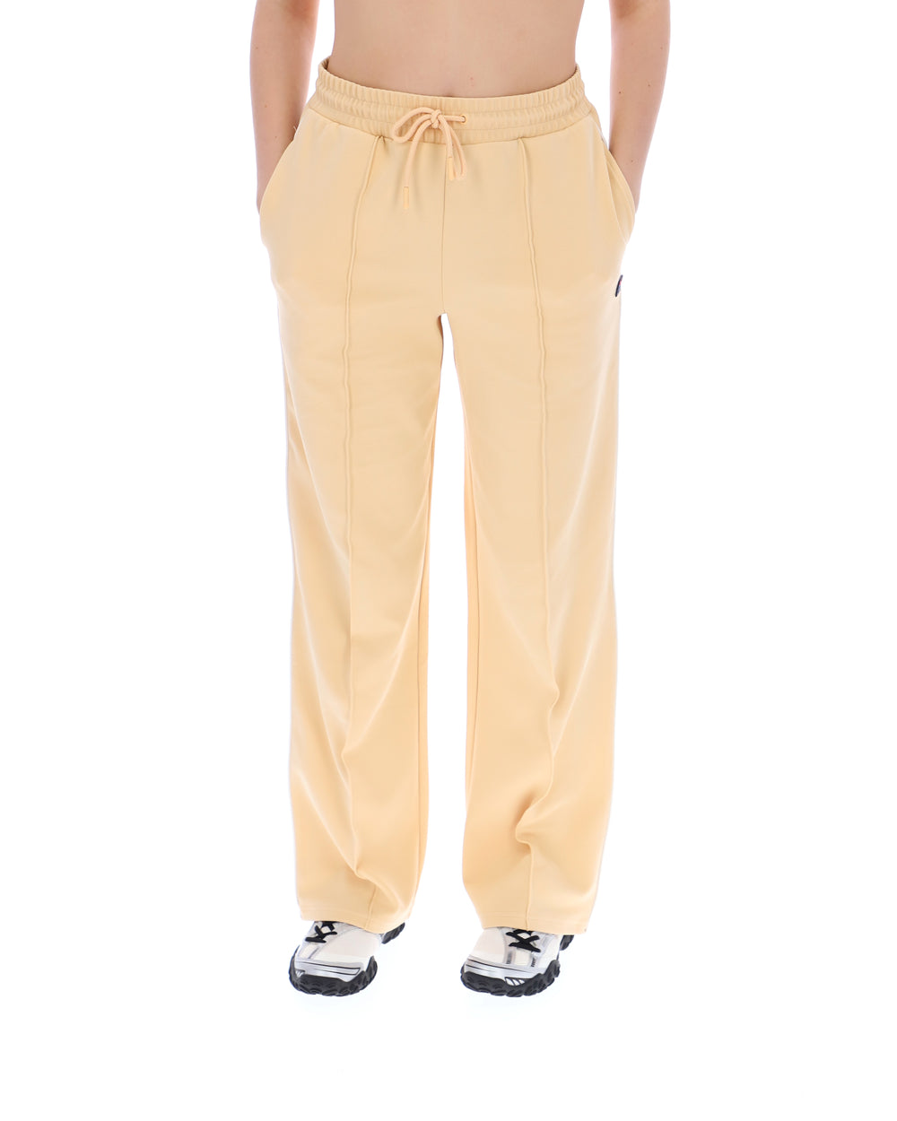 Yellow sweatpants worn by a person on a white background