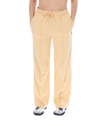 Yellow sweatpants worn by a person on a white background