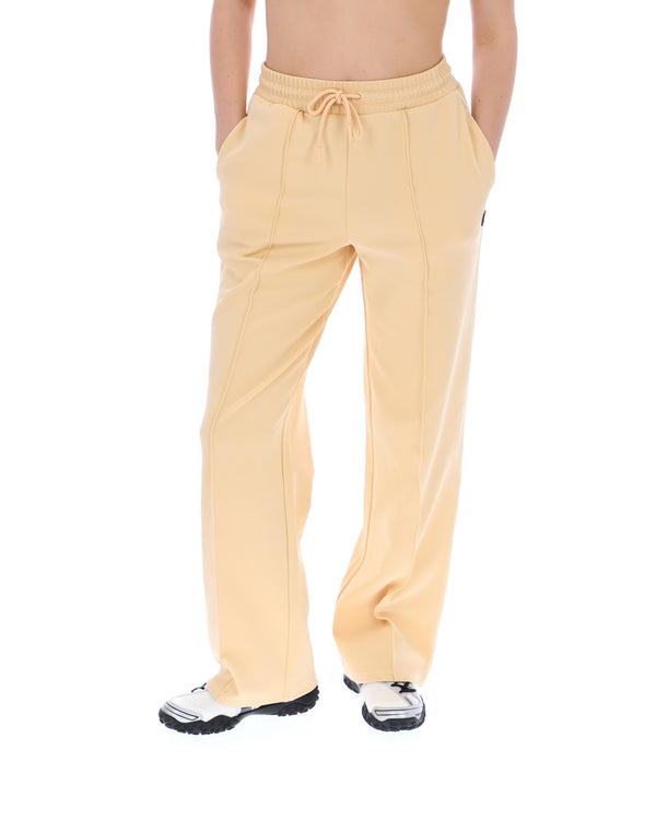 Beige pants worn by a person on a white background