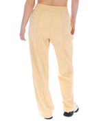 Beige pants worn by a person on a white background