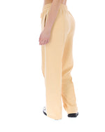 Yellow pants worn by a person on a white background