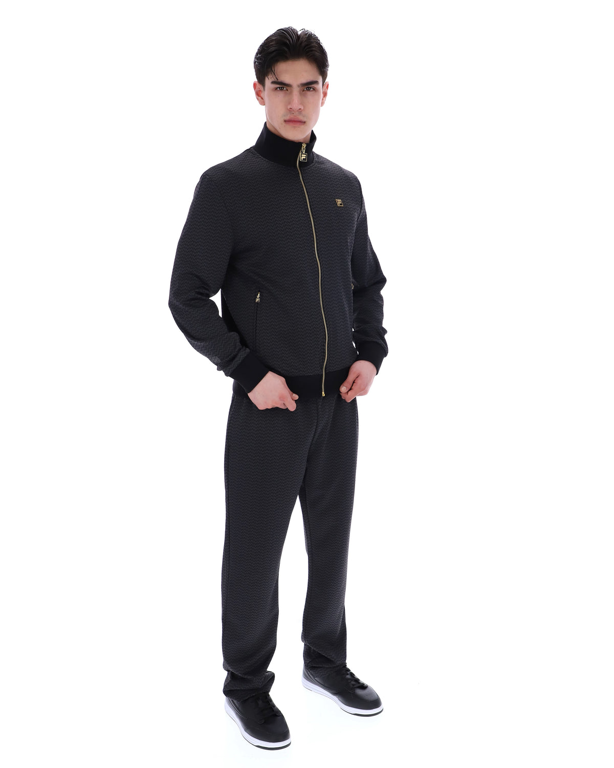 Displays a model wearing the Black 'FILA' branded Mathers Herringbone Track Top