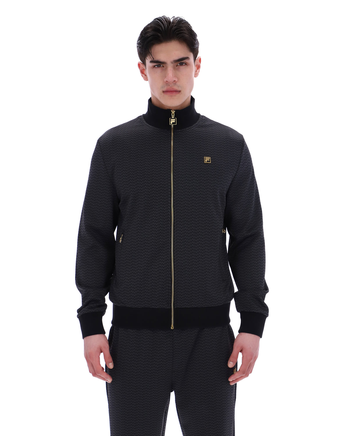 Displays a model wearing the Black 'FILA' branded Mathers Herringbone Track Top