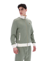 Displays a model wearing the Sea Foam 'FILA' branded Mathers Herringbone Track Top