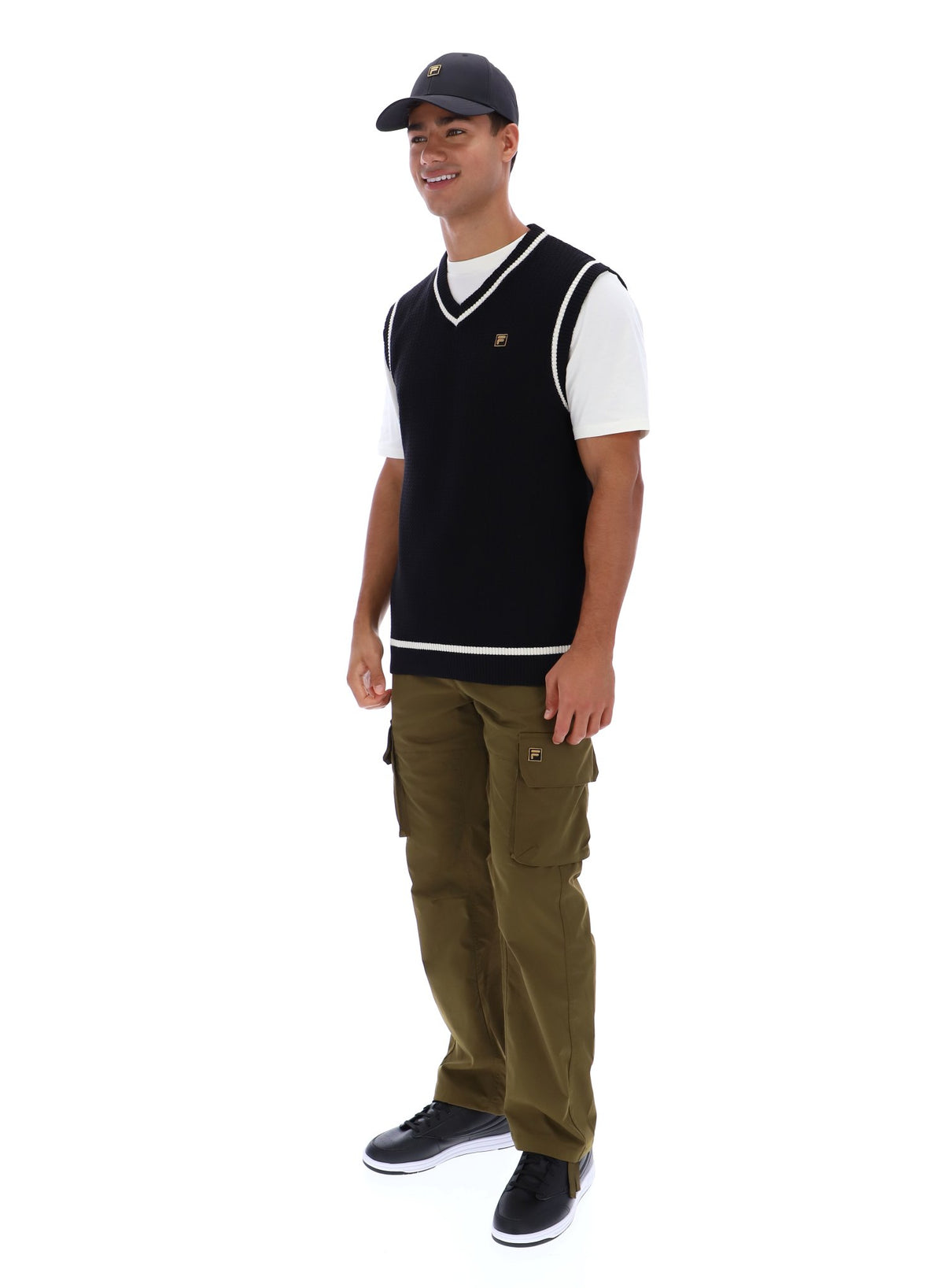 Displays a model wearing the Black 'FILA' branded Mellor Textured Knit Vest with Tipping