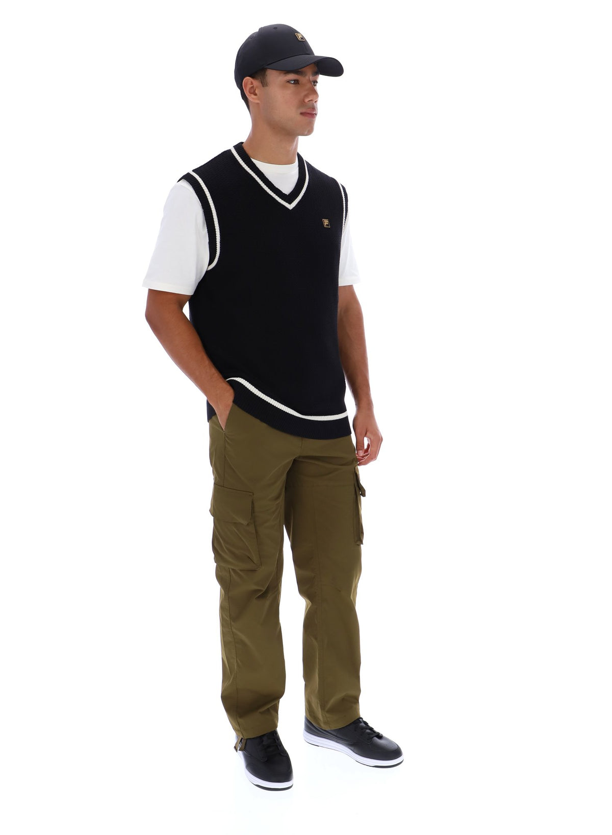 Displays a model wearing the Black 'FILA' branded Mellor Textured Knit Vest with Tipping