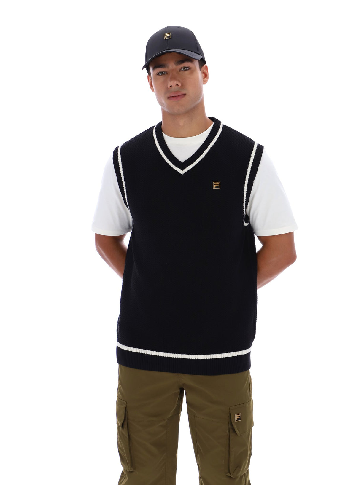 Displays a model wearing the Black 'FILA' branded Mellor Textured Knit Vest with Tipping