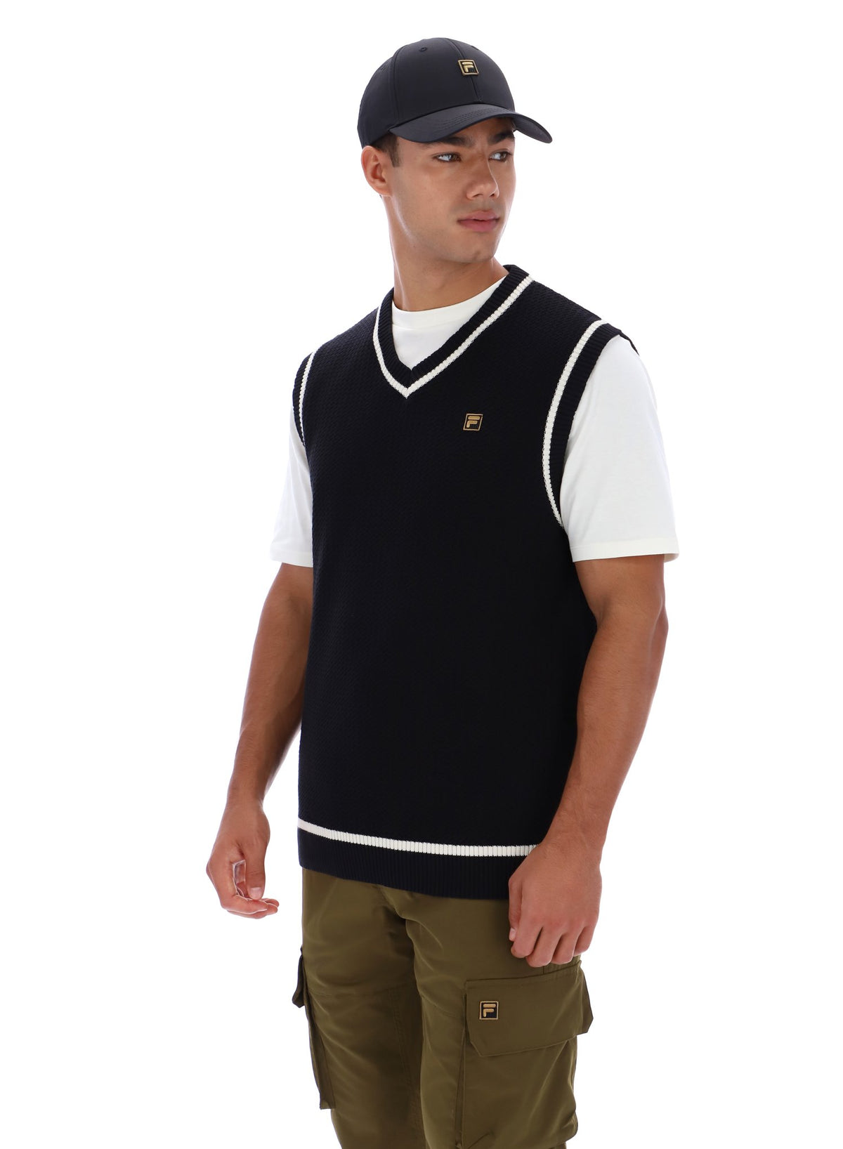 Displays a model wearing the Black 'FILA' branded Mellor Textured Knit Vest with Tipping