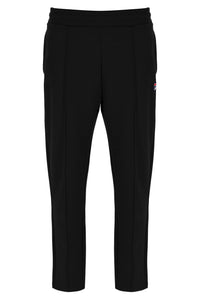 Black pants with a small red logo on a white background