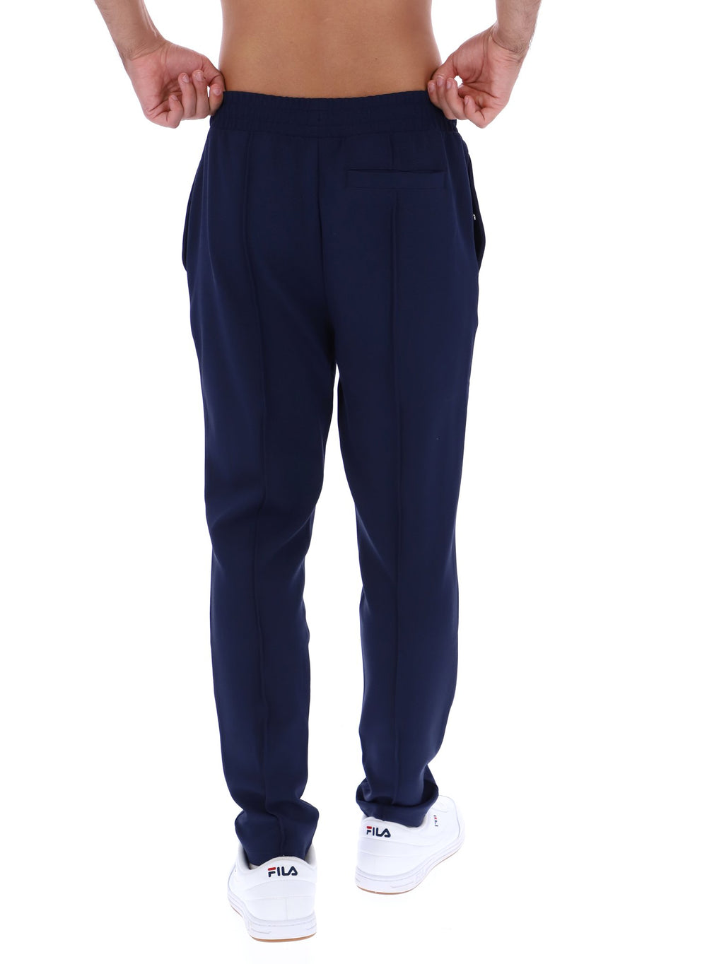Navy blue pants worn by a person on a white background