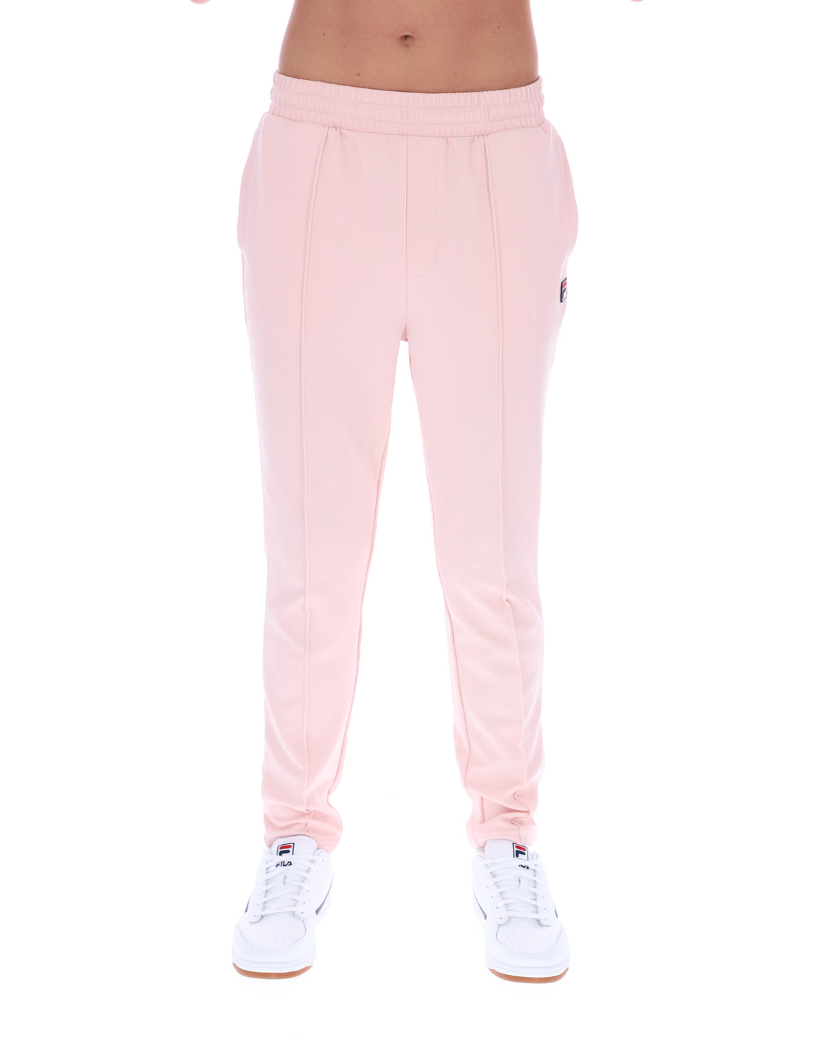 Pink sweatpants worn by a person on a white background