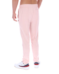 Person wearing light pink pants on a white background