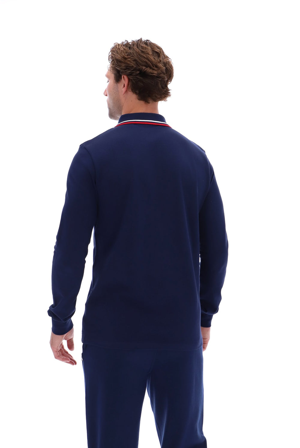 A man viewed from behind wearing a navy blue long-sleeve knit top with a red and white striped collar, paired with matching navy pants, against a solid white background.