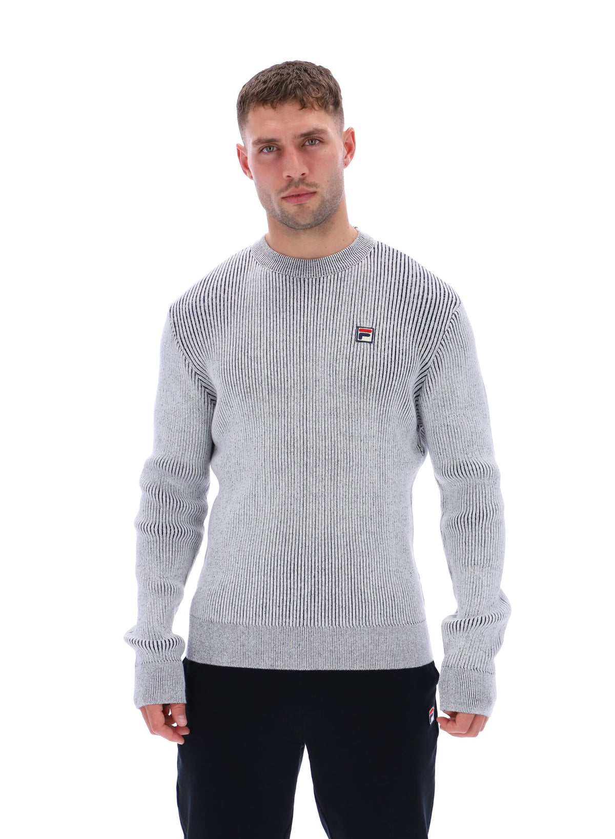 Displays a model wearing the Gardenia 'FILA' branded Noah Knitted Crew Neck