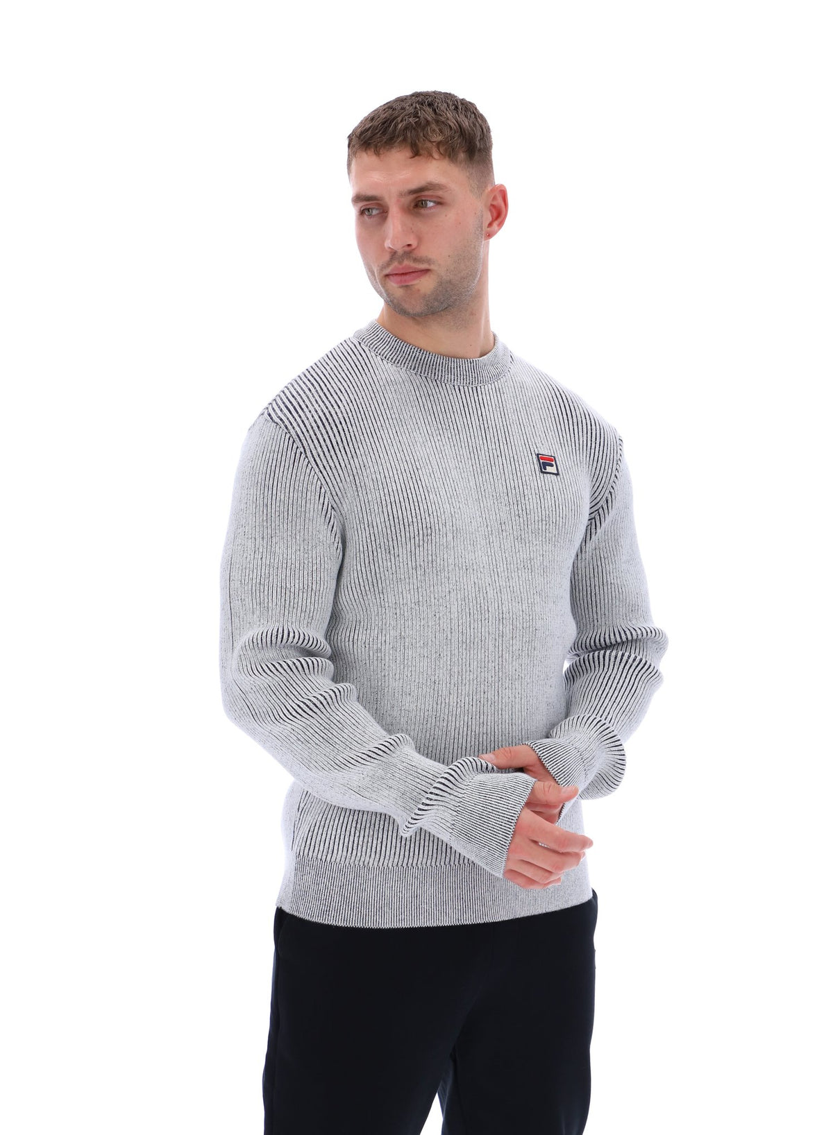 Displays a model wearing the Gardenia 'FILA' branded Noah Knitted Crew Neck
