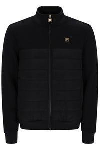 A black zip-up jacket with a quilted horizontal chest panel, a stand-up collar, and small gold Fila logo patches on the chest and zipper pull, shown against a plain white background.