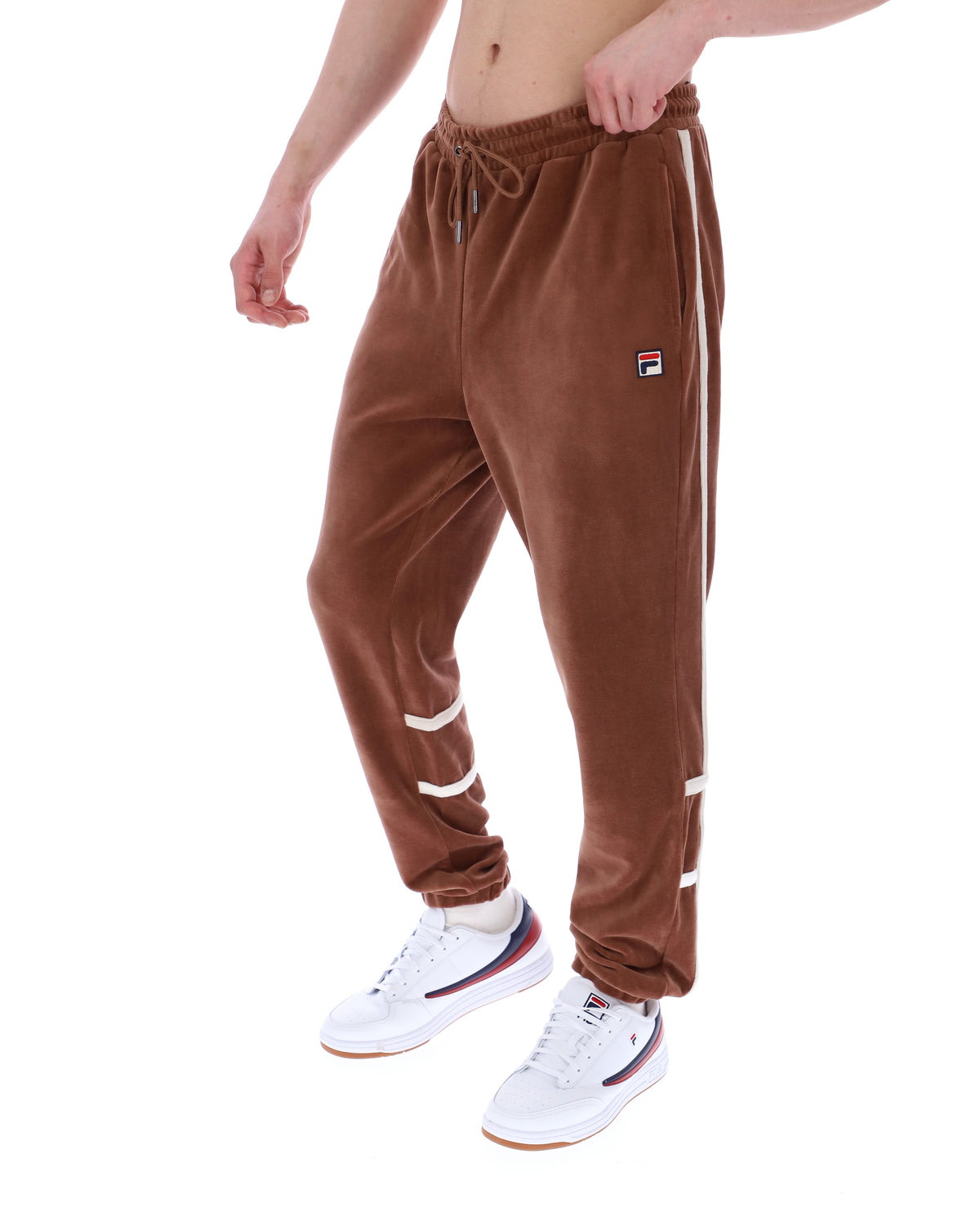 Brown velour jogger pants with white stripes on a white background