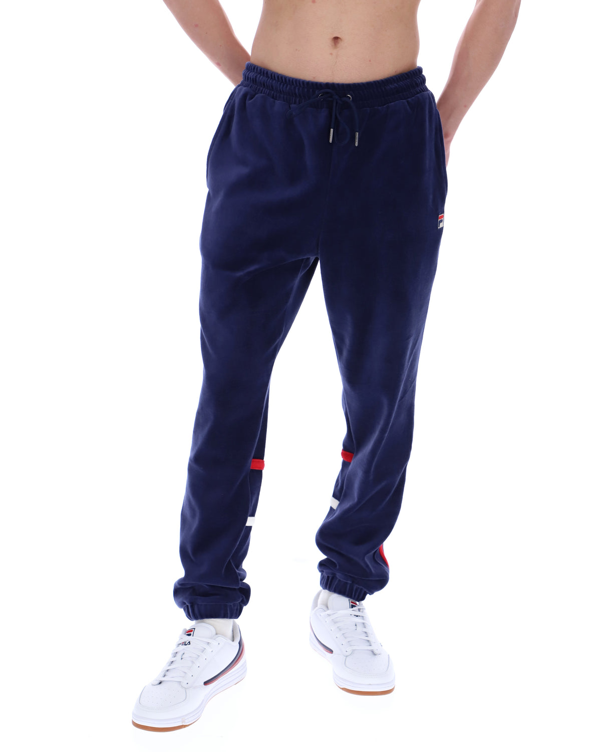 Navy blue jogger pants with red accents worn by a person on a white background