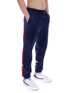 Navy blue tracksuit with red stripes worn by a person on a white background