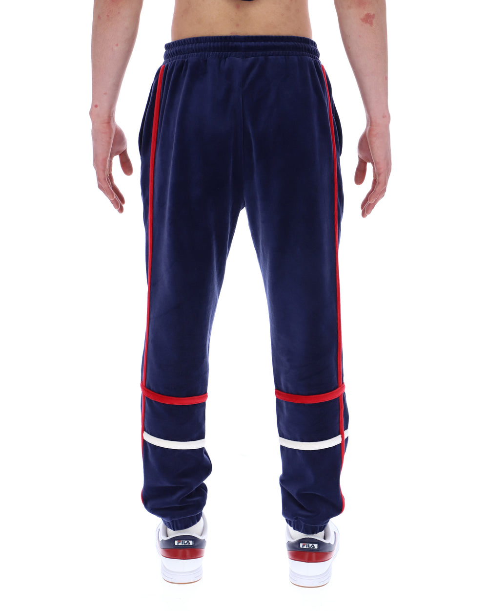 Navy blue track pants with red and white stripes on a white background