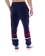 Navy blue track pants with red and white accents on a white background