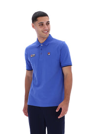 Displays a model wearing the Dazzling Blue 'FILA' branded Pablo Three-Button Tipped Rib Polo Shirt