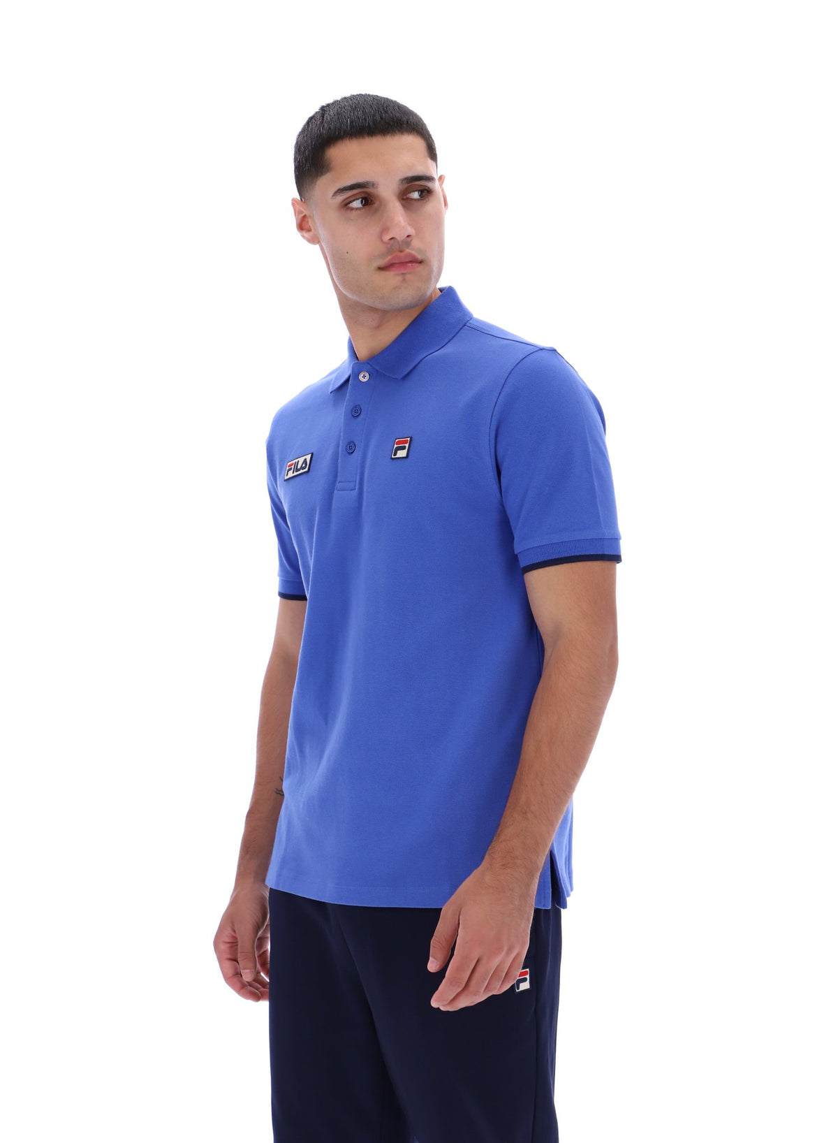 Displays a model wearing the Dazzling Blue 'FILA' branded Pablo Three-Button Tipped Rib Polo Shirt