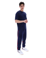 Man wearing a navy blue t-shirt with a FILA logo on the chest and sleeve on a white background