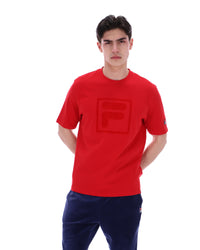 Person wearing a red t-shirt with a logo on a white background