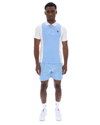Displays a model wearing the Frozen 'Fila' branded Fjord Pierro Zip Up Polo