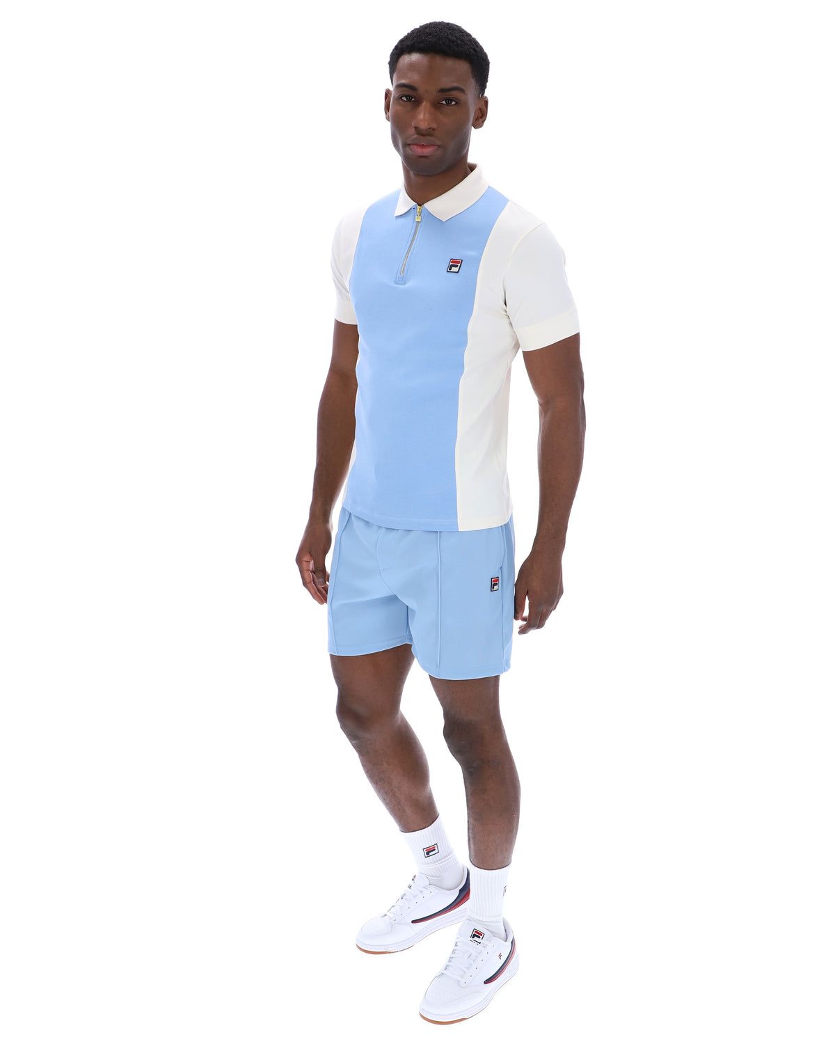 Displays a model wearing the Frozen 'Fila' branded Fjord Pierro Zip Up Polo