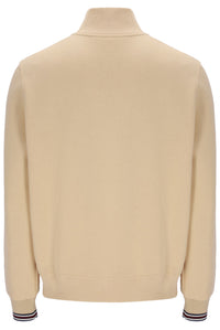 Beige sweater with striped cuffs on a white background
