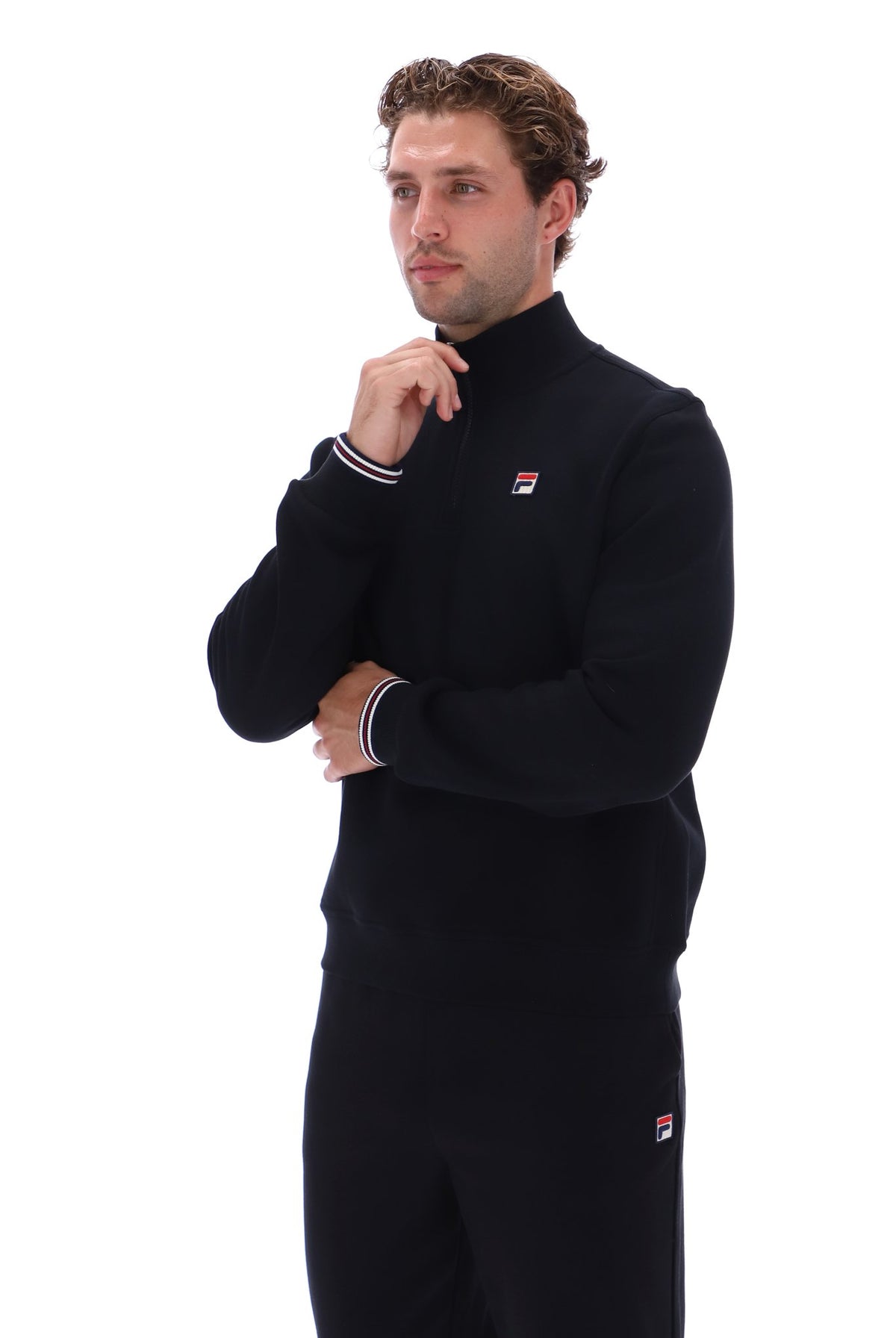 Displays a model wearing the Black 'FILA' branded Ramy F-Box 1/4 Zip