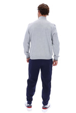A man viewed from the back wearing a light gray heathered quarter-zip sweatshirt, navy blue sweatpants, and white sneakers with red and blue accents, set against a plain white background.