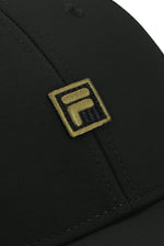 Black cap with a gold FILA logo on a white background