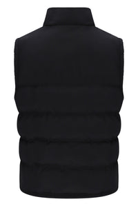 A black sleeveless puffer vest with horizontal quilting and a high stand-up collar, shown from the back on a plain white background.