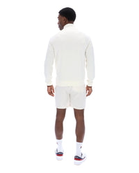 Displays a model wearing the Gardenia 'FILA' branded Rolando 1/4 Zip Neck Sweatshirt