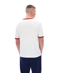 Man wearing a white sports jersey with red accents on a white background