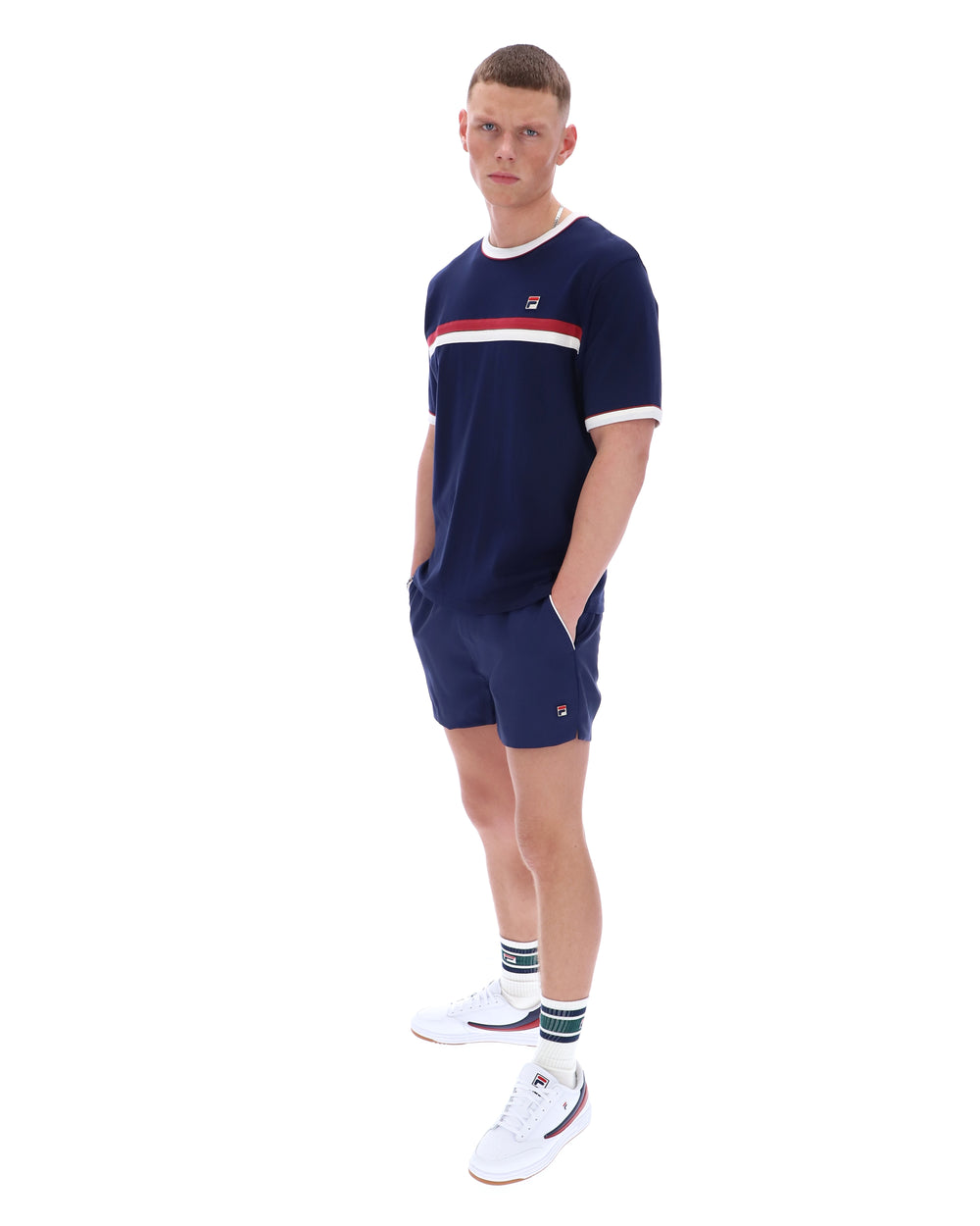Person wearing a navy blue outfit with white accents on a white background