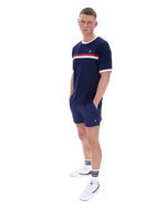 Person wearing a navy blue outfit with white accents on a white background