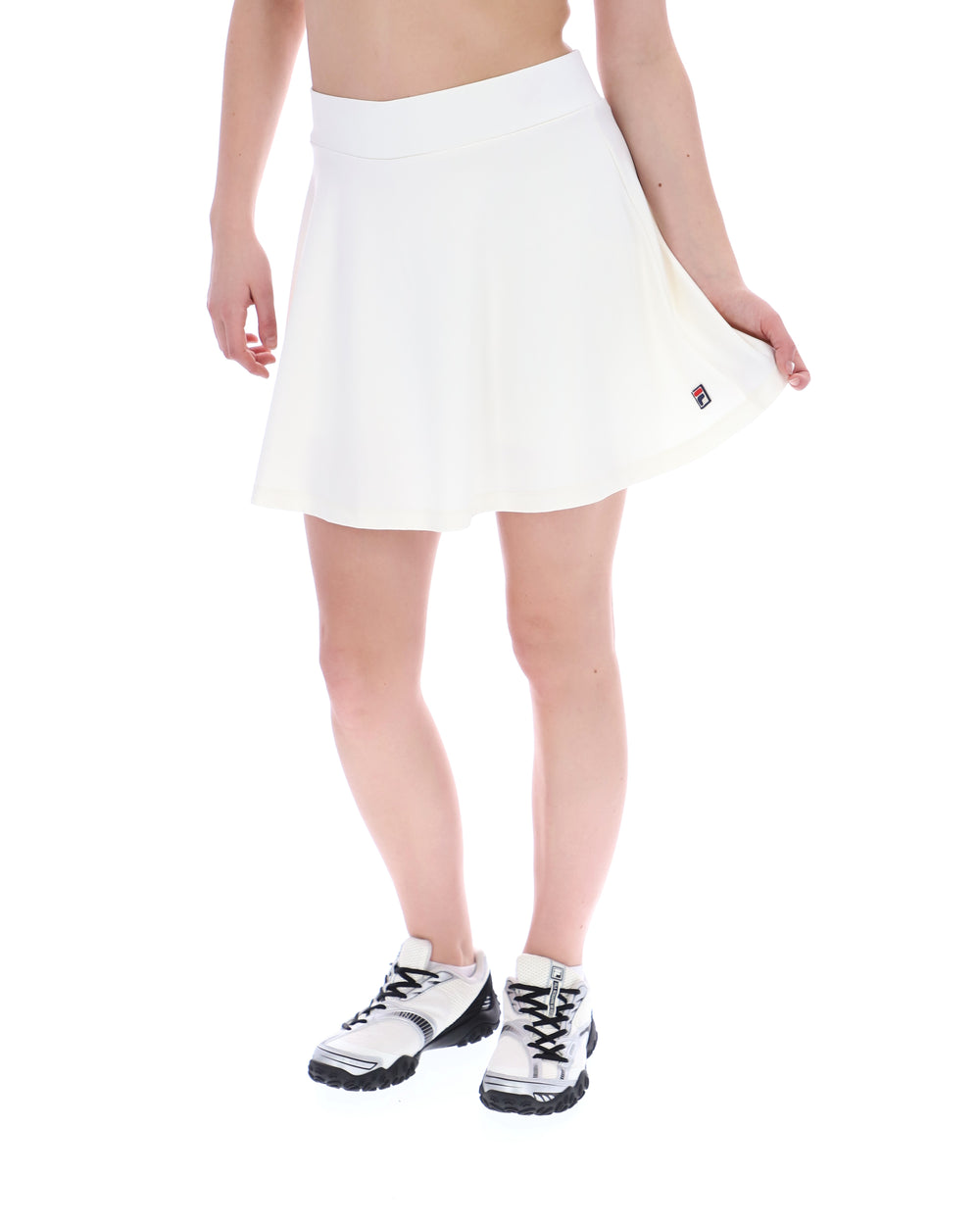 White tennis skirt worn by a person on a white background