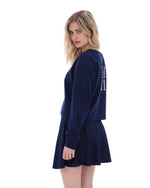 Woman wearing a navy blue dress with text on the back against a white background