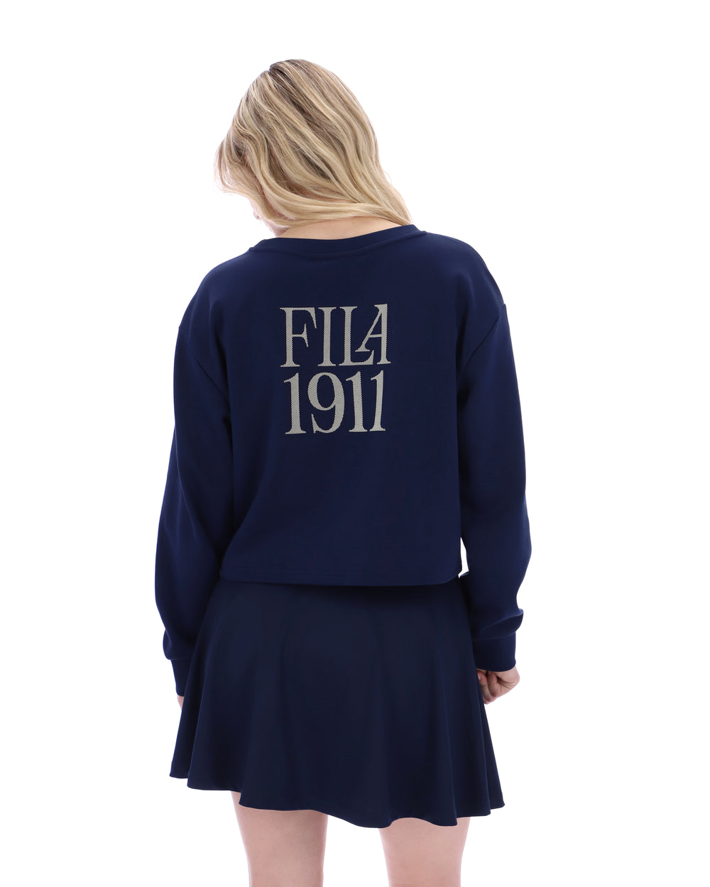 Person wearing a navy blue sweatshirt with 'FILA 1911' text on the back.